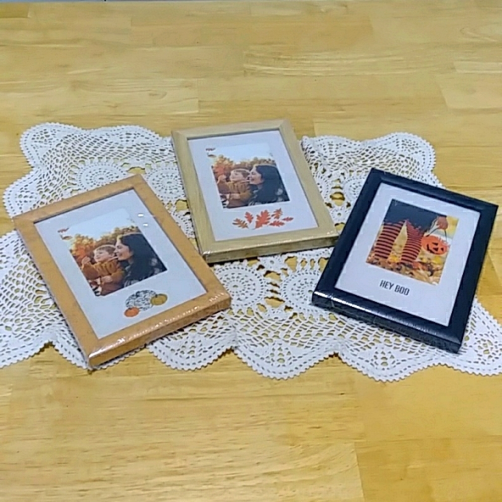 Three small picture frames, new in plastic